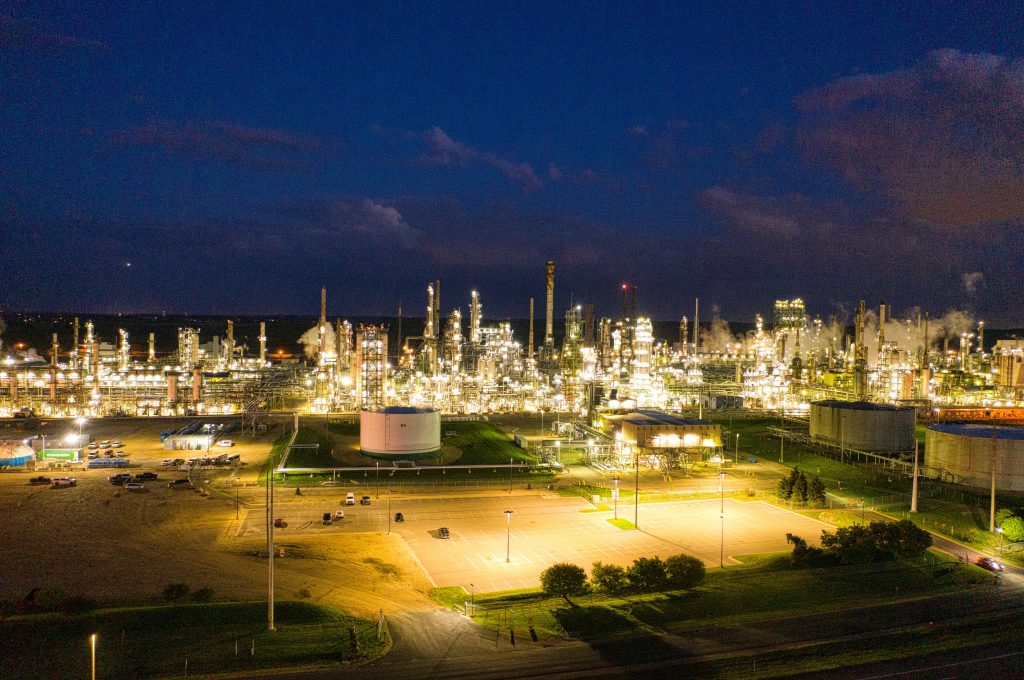 A stunning aerial shot of an illuminated oil refinery at night showcasing industrial production in Rosemount, MN.